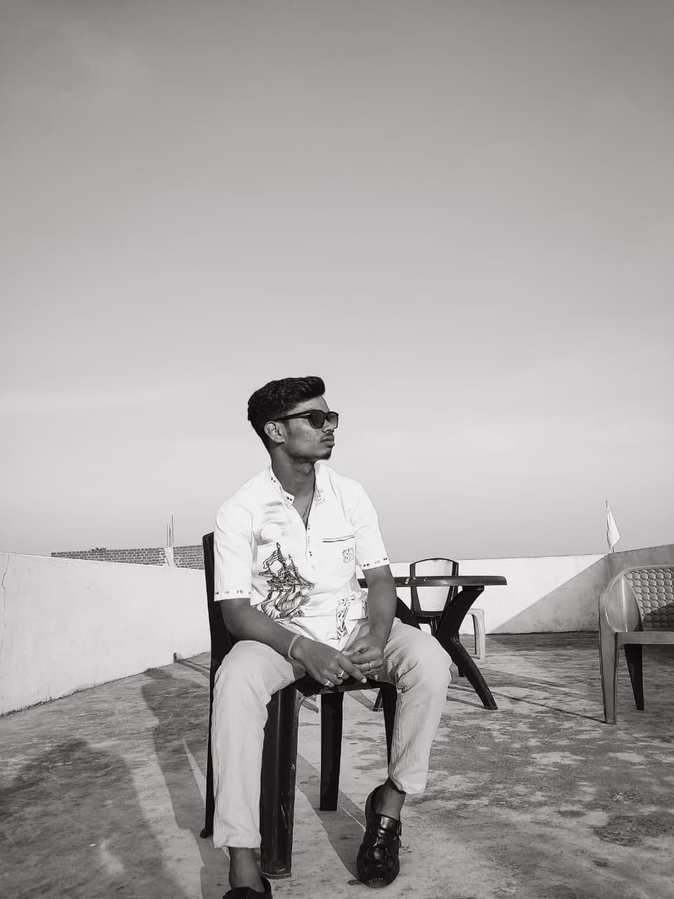 Suman standing by a large tree