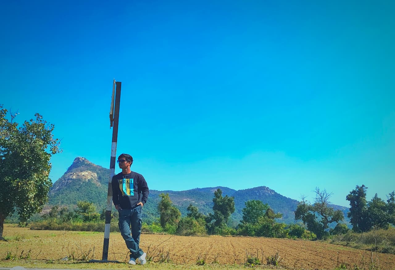 Suman in front of festive red decor